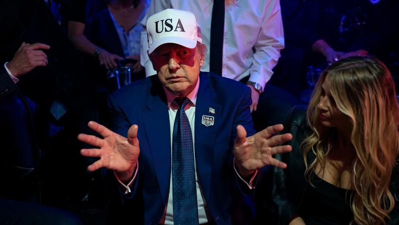 U.S. President Donald Trump gestures next to first lady Melania Trump on the South Lawn of the White House on June 15.