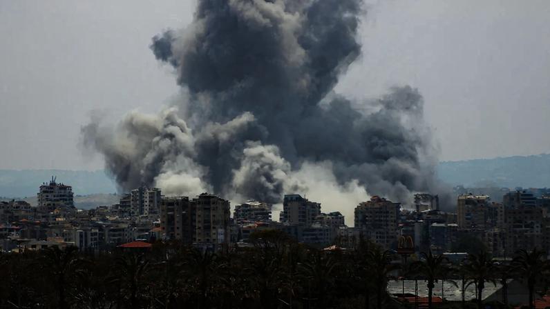 A plume of smoke from an Israeli airstrike rises above a city in southern Lebanon.