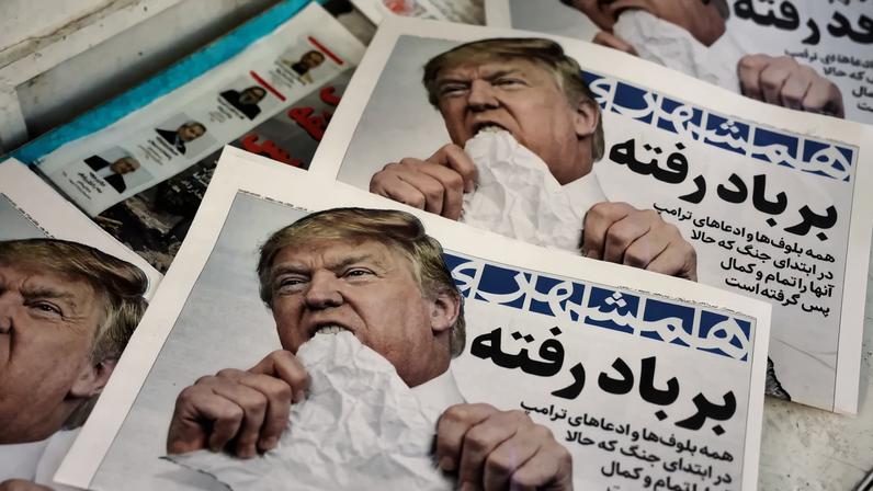 Copies of an Iranian daily newspaper bearing an image of U.S. President Donald Trump with the headline “Gone with the wind” are displayed at a kiosk in Tehran on June 18.