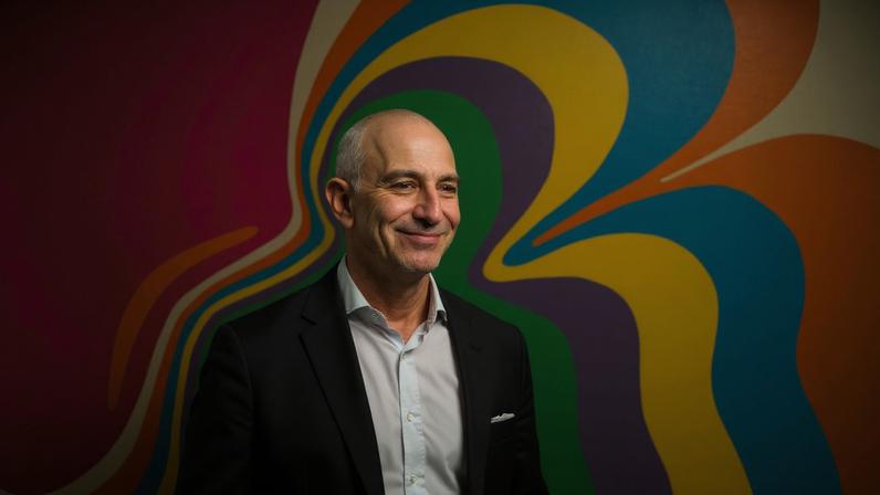 Art depicts Jeff Bezos surrounded by bright colors.