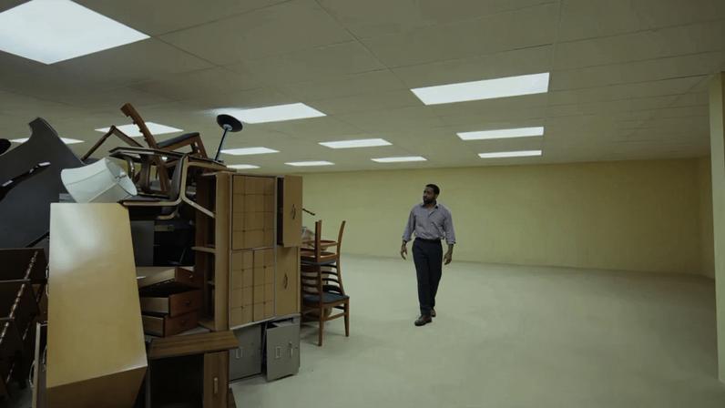 A pile of furniture and a furniture salesman in the Backrooms.