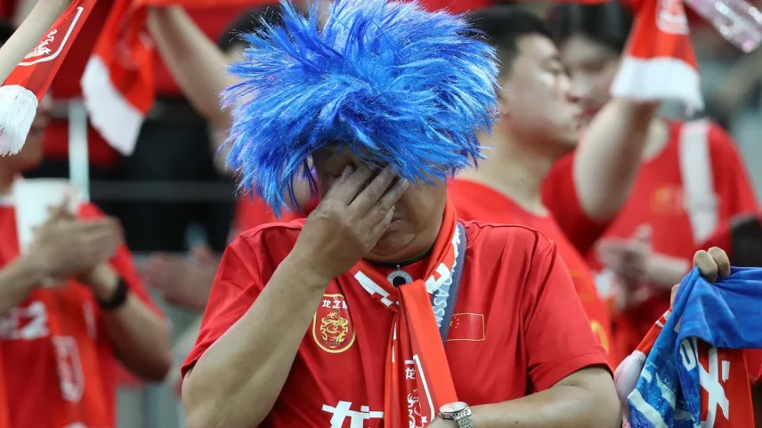 A supporter of China’s men’s national soccer team shows dejection after the team’s 0-1 defeat in a FIFA World Cup qualifier match against South Korea in Seoul.
