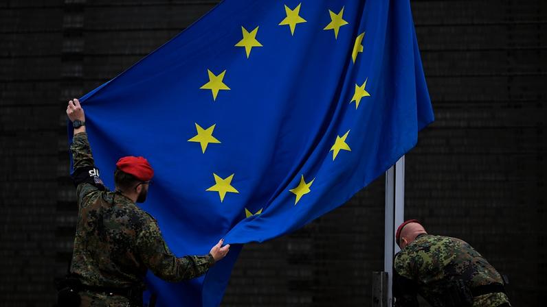 Soldiers of the German armed forces Bundeswehr hoist a European flag in front of the Bundeswehr memorial dedicated to members of the German armed forces who lost their lives in the line of duty, on November 10, 2025 on the premises of the German Defence Ministry in Berlin, prior to a wreath-laying ceremony.
