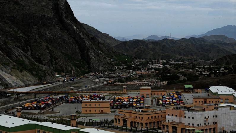 Trucks for Afghan refugees are parked as they await deportation along the Landi Kotal highway near the border in Khyber Pakhtunkhwa province, Pakistan.