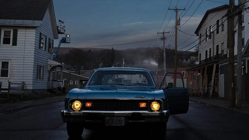 In this exclusive behind-the-scenes image from the photo set in Adams, Massachusetts, Crewdson talks with Bridgers behind the wheel.