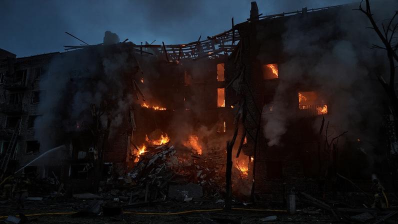 Firefighters extinguish a fire in an apartment building partially destroyed by a Russian strike in Kyiv, Ukraine.