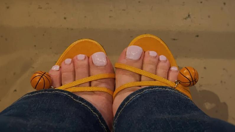 Sydney Sweeney wore vintage Manolo Blahnik orange sandals with mini basketball charms to Game 4 of the NBA Finals.